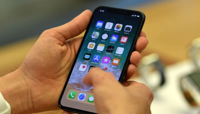 A person can be seen using an iPhone. — AFP/File