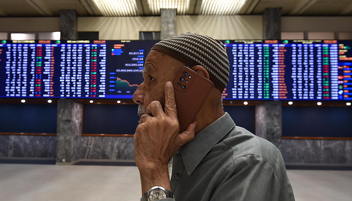 A stockbroker monitors the share prices during a trading session at the Pakistan Stock Exchange (PSX) in Karachi. — INP