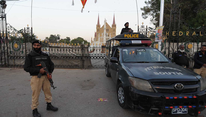 Karachi police personnel stand guard at a Church ahead of Christmas on December 22, 2023. — INP