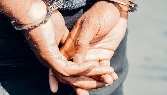 A representational image of a handcuffed person. — Pexels