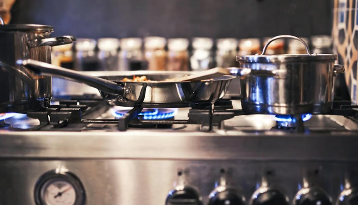 A representational image of a stove in which multiple flames are burning. — Pexels