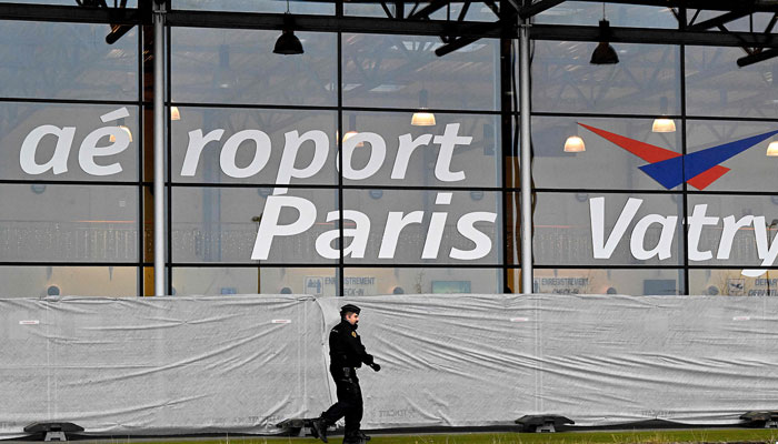 A French gendarme patrols around a terminal at Vatry airport, north-eastern France, on December 23, 2023. — AFP