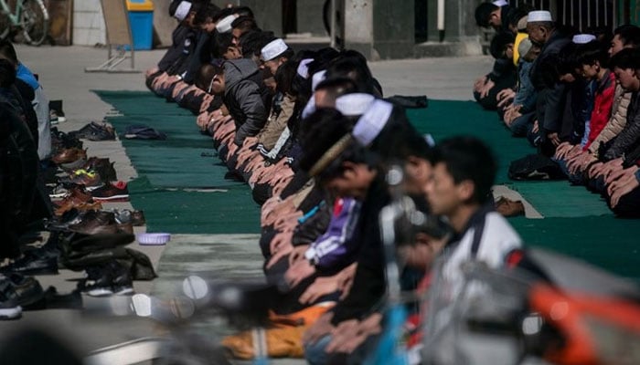 Men pray at the Nanguan Mosque in Linxia, China. — AFP/File