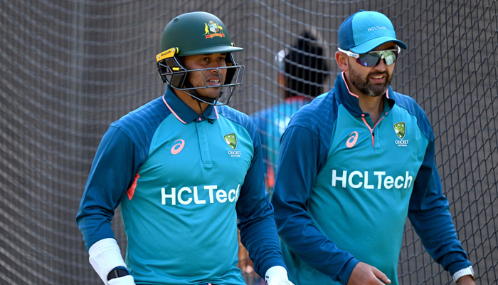 Australian batsman Usman Khawaja (L) chats with teammate Nathan Lyon (R) in the nets during a practice session at the Melbourne Cricket Ground (MCG) in Melbourne on December 24, 2023. — AFP
