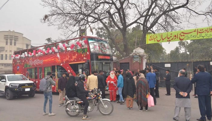 In this picture, people stand next to a double-tracker bus provided by Tourism Development Corporation Punjab (TDCP) on the occasion of Christmas on December 24, 2023. — Facebook/Tourism Development Corporation of Punjab