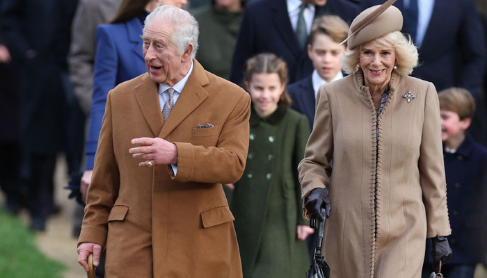 Britains King Charles III (L) and Queen Camilla (R) arrive for the Royal Familys traditional Christmas Day service at St Mary Magdalene Church in Sandringham in eastern England, on December 25, 2023. — AFP