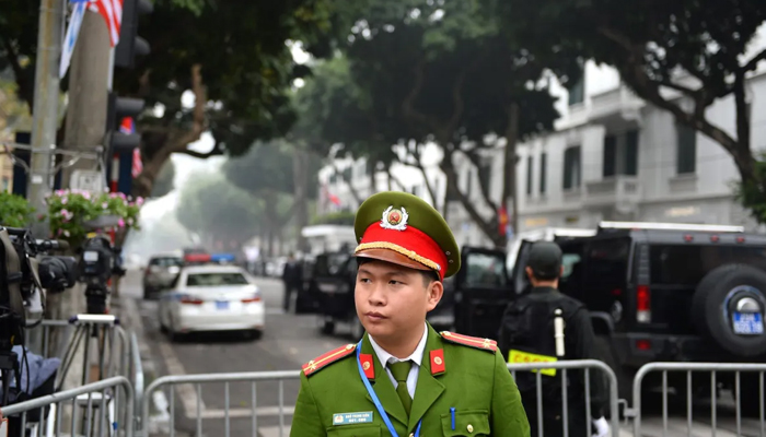 A Vietnamese policeman stands guard outside the Sofitel Legend Metropole hotel in Hanoi. — AFP/File