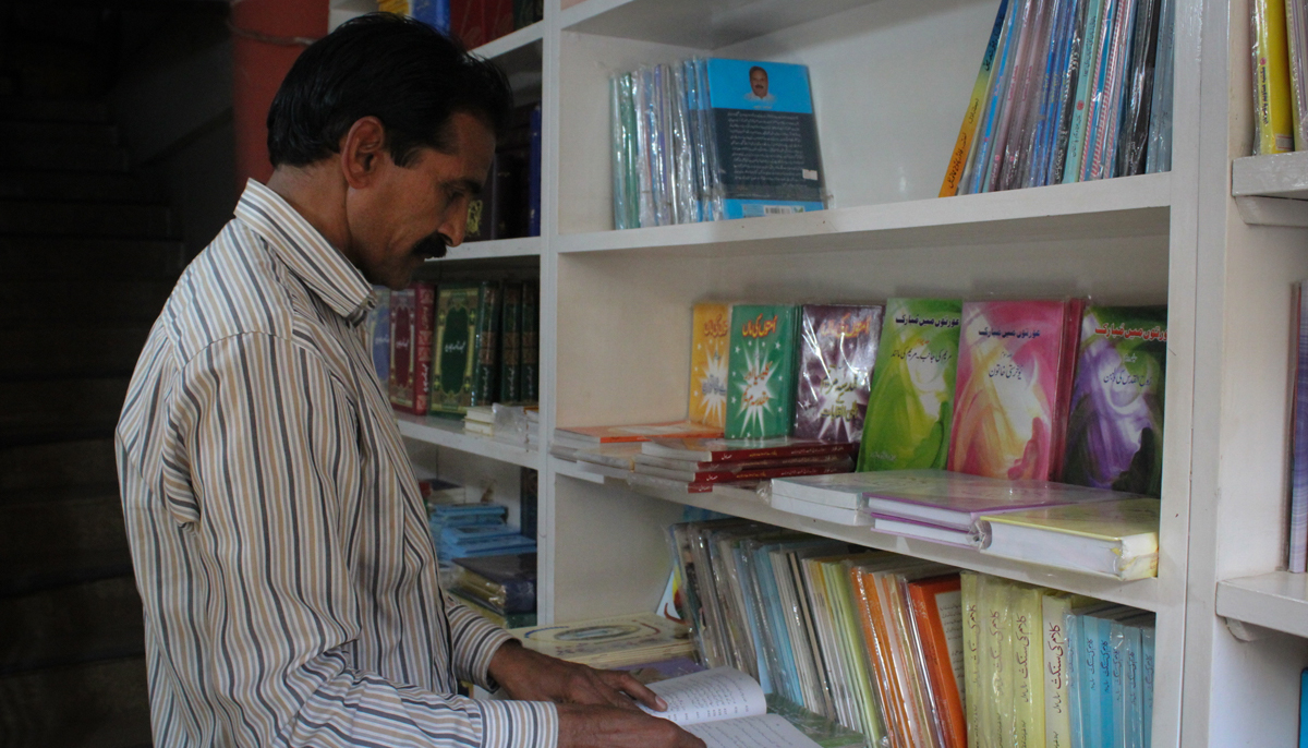 Lateef Masih goes through the stores books section. — Photo by author