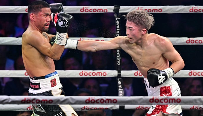 Japans WBC and WBO super bantamweight champion Naoya Inoue (R) fights with Philippines WBA and IBF super bantamweight champion Marlon Tapales during their four-belt world super bantamweight title unification match at Tokyo´s Ariake Arena on December 26, 2023. — AFP