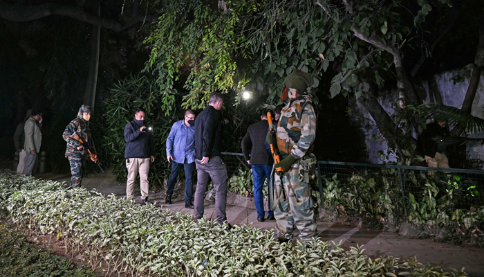 Officials along with police personnel conduct a search operation after an alleged explosion occurred near the embassy in New Delhi on December 26, 2023. — AFP
