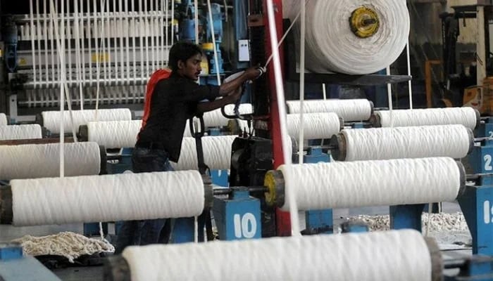 An employee working at a textile factory in Pakistans port city of Karachi. — AFP/File