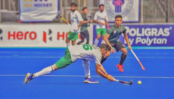 Pakistans hockey team player (in white shirt) plays a shot against Indonesia in Asia Hockey Cup 22 in Jakarta, Indonesia, on May 24, 2022. — Pakistan Hockey Federation