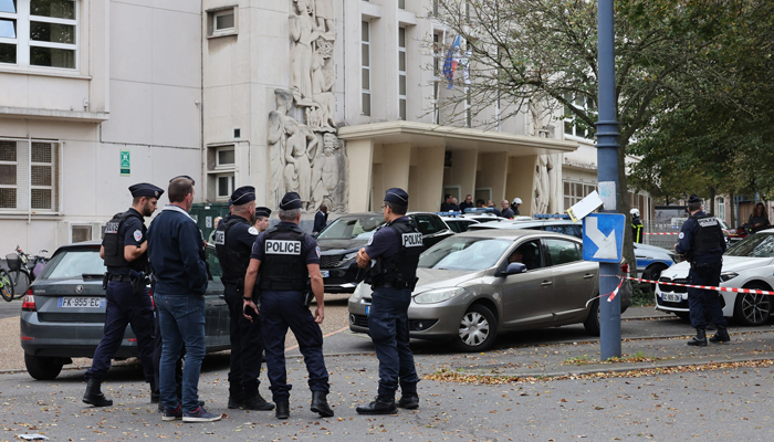 This image shows French police officials standing at a crime scene. — AFP/File
