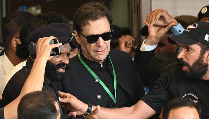 Pakistans former Prime Minister Imran Khan (C) leaves after appearing in the Supreme Court in Islamabad on July 24, 2023. — AFP