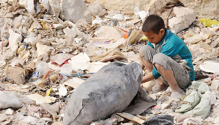 A child scavenges through a garbage pile. — ILO