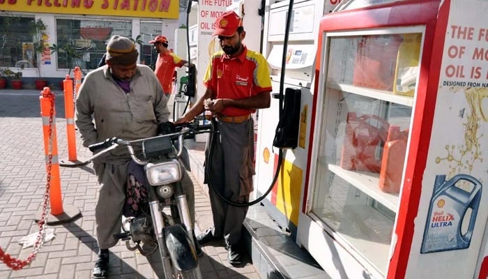 Fuel station worker filling petrol in a motorbike at a fuel station on January 29, 2023. — PPI