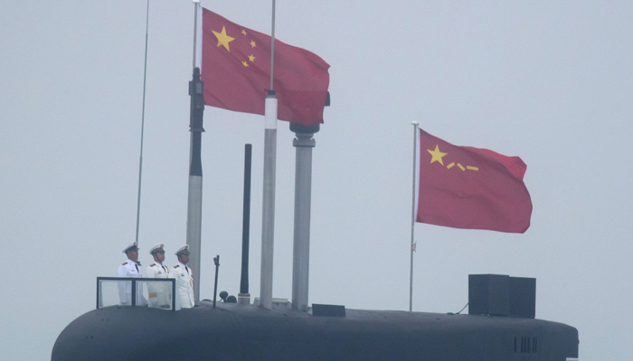 Chinese Navy personnel stand on a submarine. - AFP/File