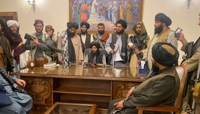 Taliban leaders sit in an office. — AFP