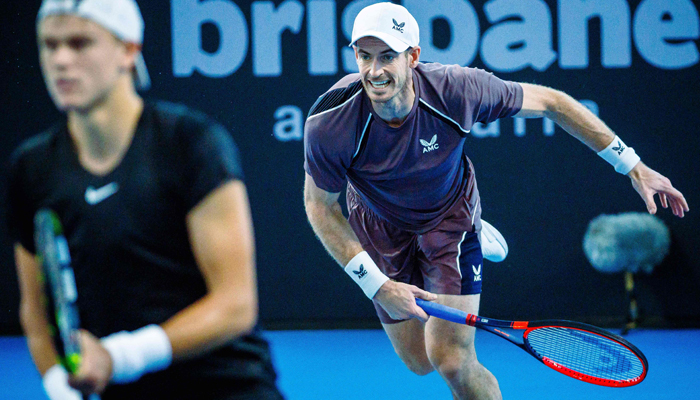 Britains Andy Murray hits a return during his mens doubles match with partner Holger Rune of Denmark against Russian duo Aslan Karatsev and Roman Safiullin at the Brisbane International tennis tournament in Brisbane on December 31, 2023. — AFP