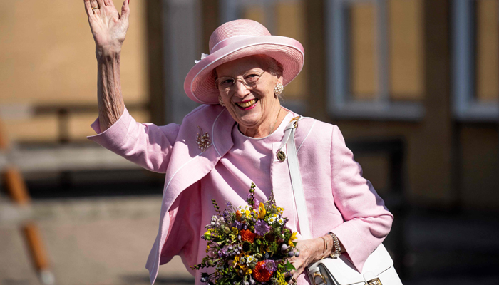 Queen Margrethe II of Denmark waves to onlookers as she visits Fredericia Municipality, Denmark, on September 1, 2023, which hosts the Queens late summer procession. — AFP