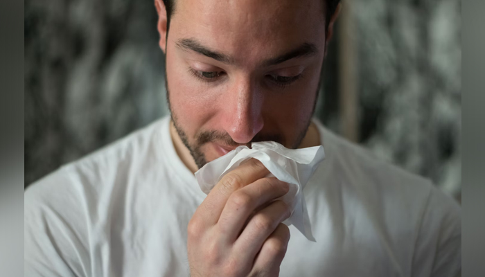 This representational image shows a man afflicted with the flu. — Unsplash