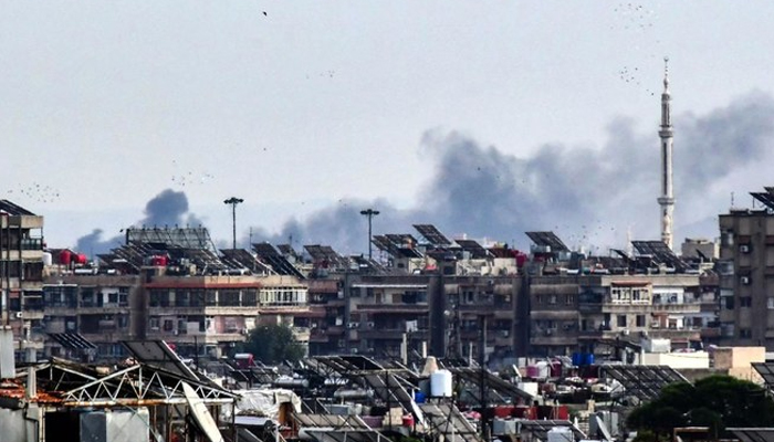 Smoke billows above buildings after an Israeli strike on the outskirts of Damascus on November 22, 2023. — AFP