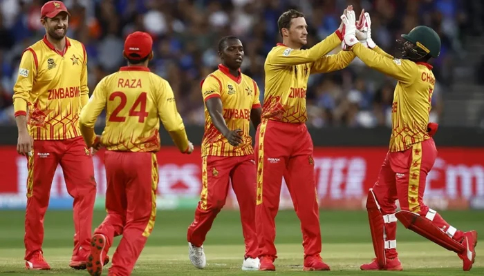 Zimbabwe players celebrate after taking a wicket. — AFP