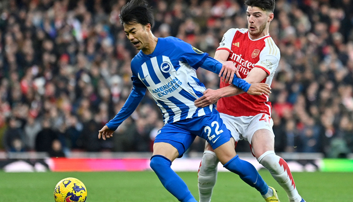 Arsenals Declan Rice (R) fouls Brightons Kaoru Mitoma during the English Premier League football match between Arsenal and Brighton and Hove Albion at the Emirates Stadium in London on December 17, 2023. — AFP