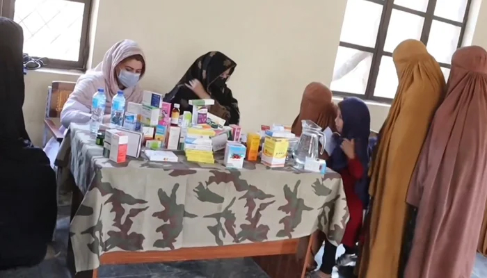 This screengrab taken from a video released on October 30, 2023, shows local female residents seeking medical assistance from the staff accompanied by their children. — Facebook/Hafiz Abdul Hadi