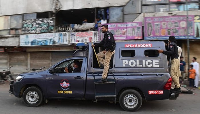 Police patrol in a market area in Karachi. —AFP/File