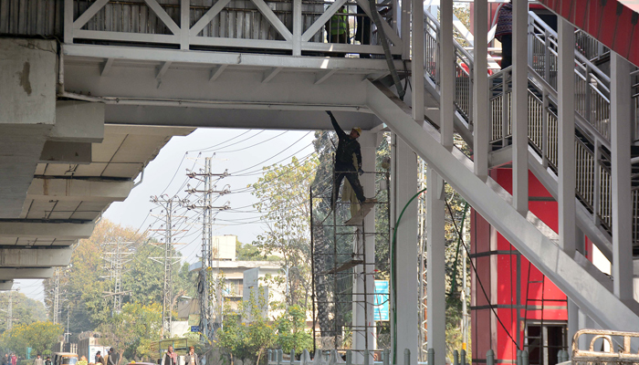 A laborer is busy in paint the metro bus station during the renovation work in progress as the metro station closed after the 9th May incident in the city.— ONLINE