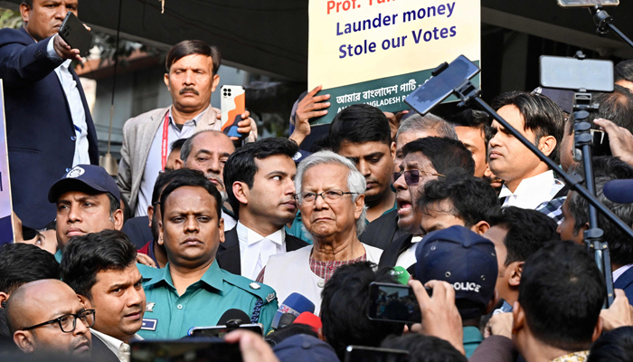 Bangladeshi Nobel peace laureate Muhammad Yunus (C) steps out of a court in Dhaka on January 1, 2024.— AFP