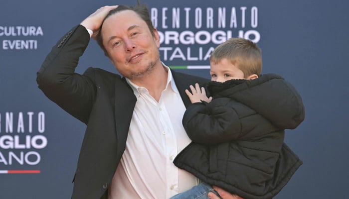 X (formerly Twitter) CEO Elon Musk holds his son as he arrives at the Atreju political meeting organised by the young militants of Italian right-wing party Brothers of Italy (Fratelli d´Italia) on December 16, 2023, at the SantAngelo Castle in Rome. — AFP
