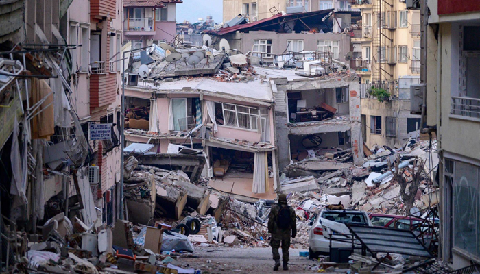 A Turkish soldier walks among buildings destroyed by the February 6 earthquakes in Hatay, Turkey. — AFP