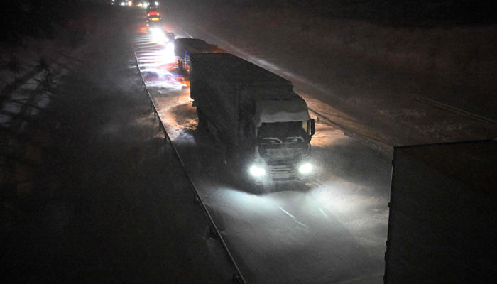 Vehicles are stuck on the European route E22 at Ekeroed near Hoerby in southern Sweden on January 3, 2024. — AFP