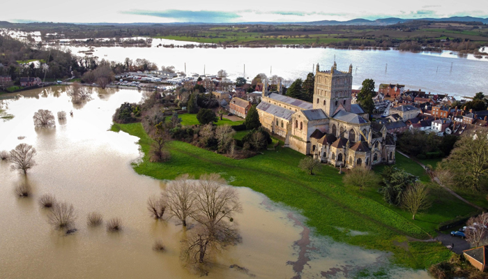 An aerial view shows Tewkesbury Abbey surrounded by floodwater after the Rivers Swilgate and Avon burst their banks in Tewkesbury, western England on January 3, 2024, following Storm Henk. — AFP