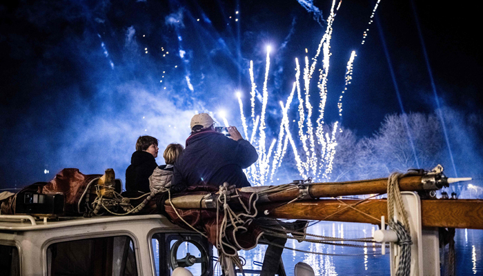 Spectators enjoy fireworks in the Piushaven in Tilburg, on January 1, 2024. — AFP