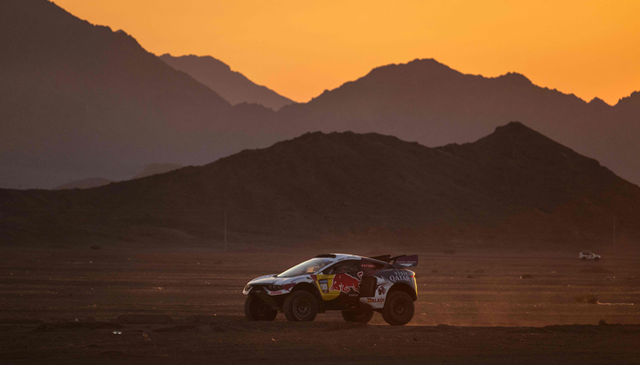Nasser Racings Qatari driver Nasser Al-Attiyah and French co-driver Mathieu Baumel drive their car to the camp at sunset in Al-Ula, Saudi Arabia, on January 4, 2024, on the eve of the start of the Dakar rally 2024. — AFP