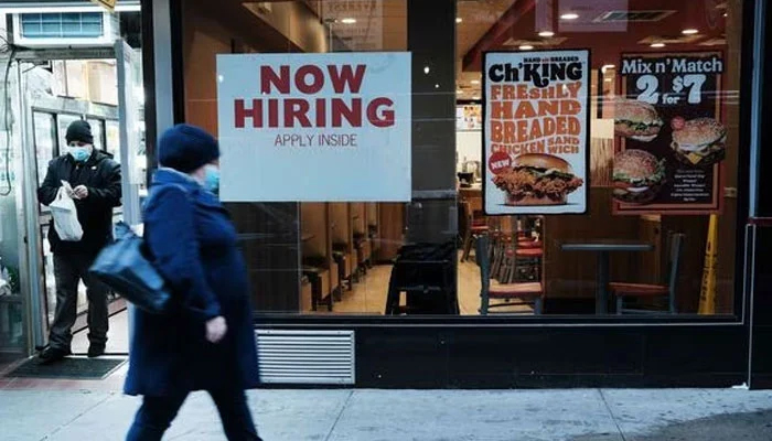 A person walks by a sign advertising employment at a fast-food restaurant in New York City. — AFP File