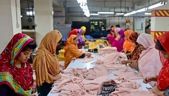 In this photograph taken on April 13, 2023, women work at a garment factory.—AFP