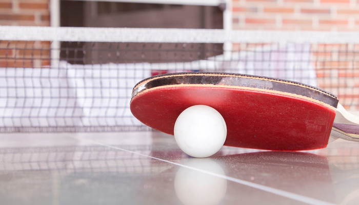 This representational image shows a table tennis racket and a ball. — Pexels
