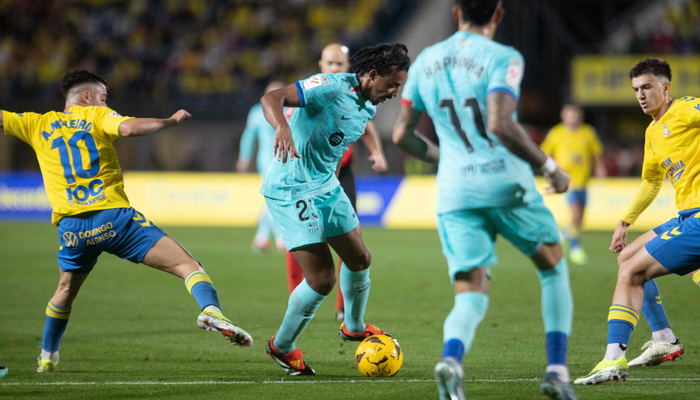 Barcelonas Jules Kounde vies with Las Palmas Alberto Moleiro during the Spanish league football match at the Gran Canaria stadium in Las Palmas de Gran Canaria, on January 4, 2024. — AFP