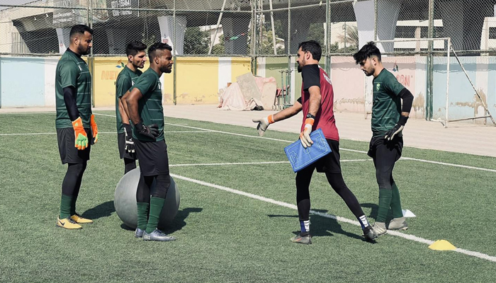 This image shows a trainer interacting with the footballers in the field on December 30, 2023. — Facebook/Pakistan Football Federation