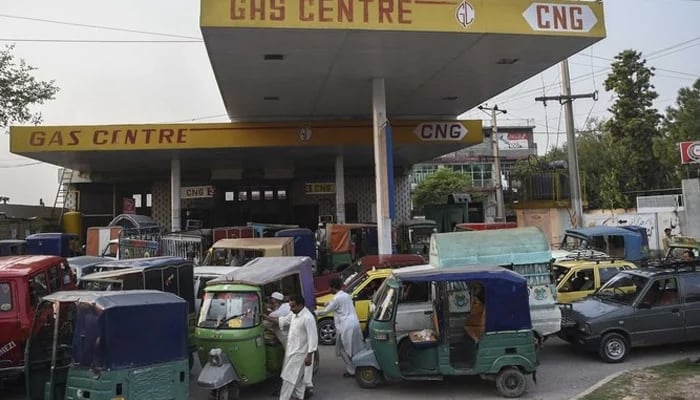 Motorists queue to refill their vehicles with Compressed Natural Gas (CNG) at a CNG station in Peshawar. — AFP/File
