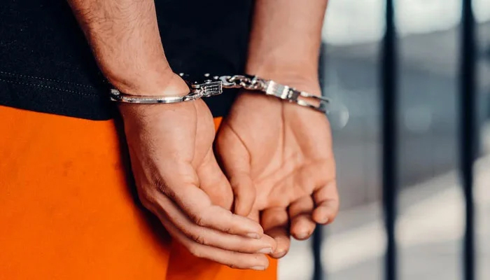 A representational image of a handcuffed man. — Pexels