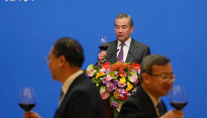 Chinese Foreign Minister Wang Yi (C) gives a toast after delivering a speech at a reception to commemorate the 45th anniversary of China-US diplomatic relations at the Diaoyutai Guest House in Beijing on January 5, 2024. — AFP