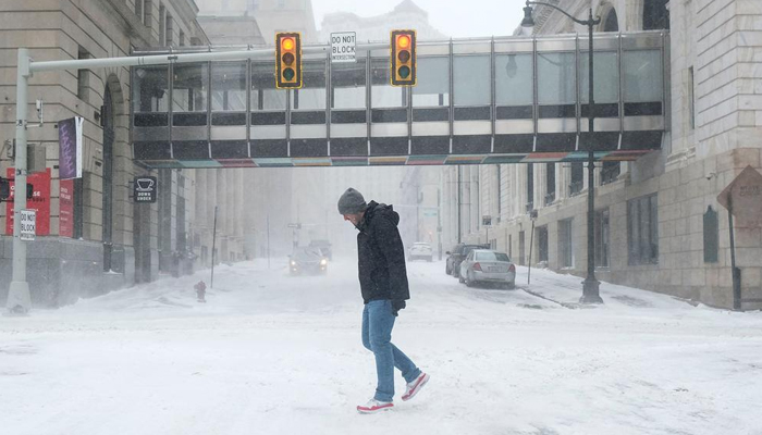 This image shows a person walking amid the winter storm in the US. — AFP/File