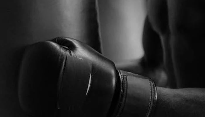 This representational image shows a boxing gulf-wearied man. — Pexels