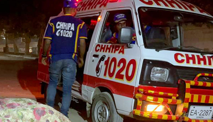 Chippa volunteer stands next to the ambulance in Karachi on January 2, 2023. — Facebook/Chhipa Welfare Association