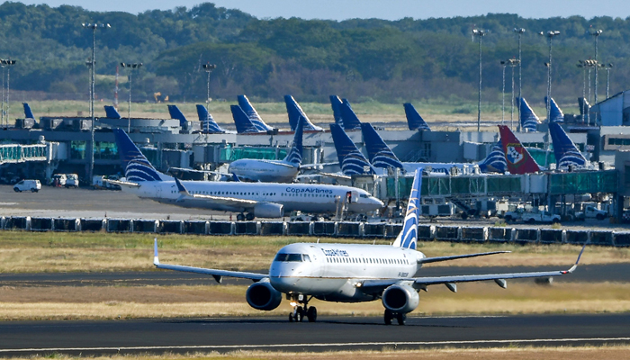 A Copa airlines plane taxis on a runway as others sit on the tarmac at Tocumen International Airport, on March 22, 2020 during the global pandemic of the new coronavirus, COVID-19. — AFP